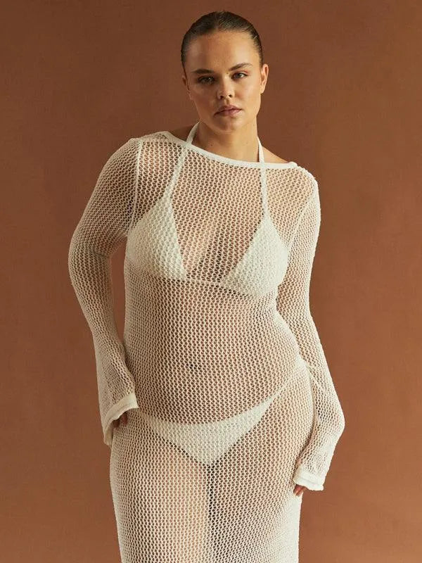 Woman in a white sheer open-knit long-sleeve cover-up over a white bikini fashion image